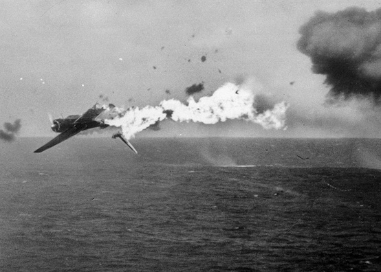 Photo:  A Japanese torpedo bomber goes down in flames after a direct hit by 5
